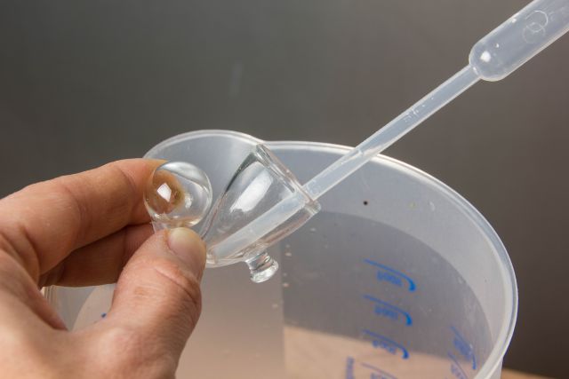 cleaning a drop checker with a pipette